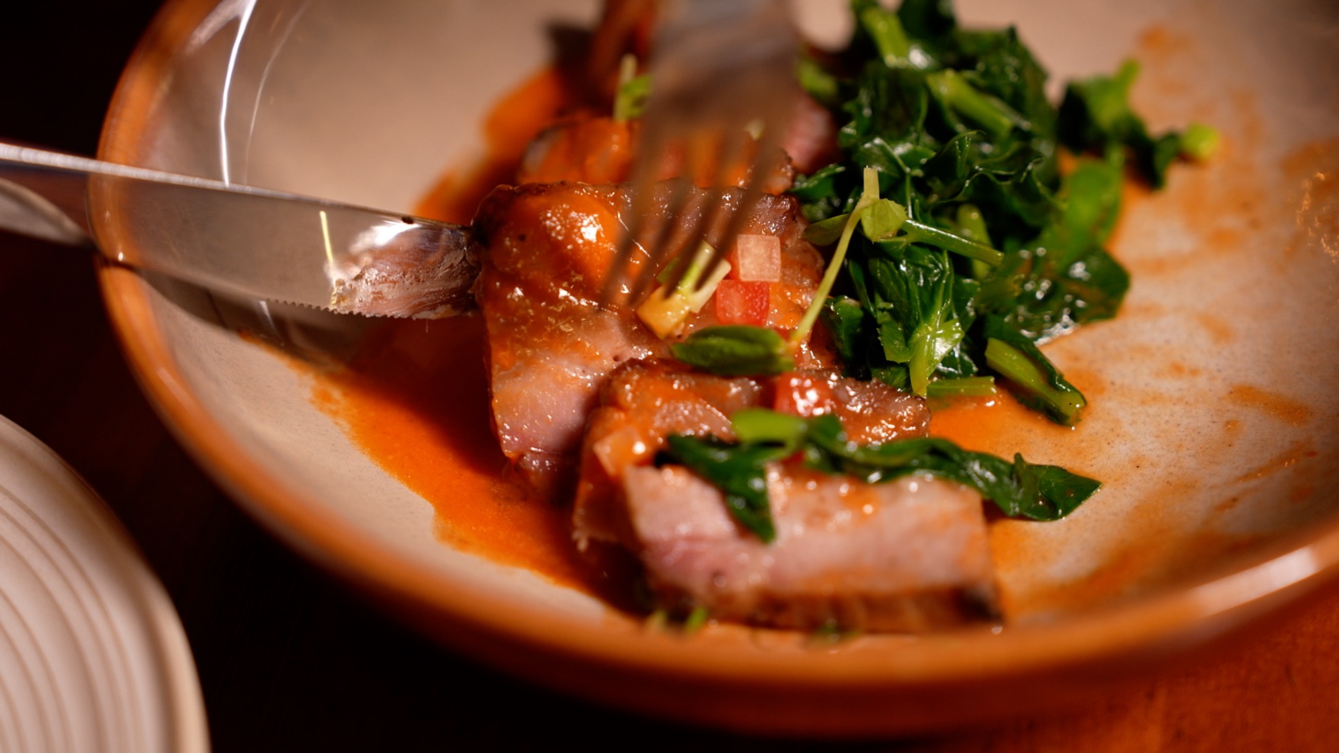 Slow-cooked roast pork neck is flavored with Guizhou sour soup. /CGTN