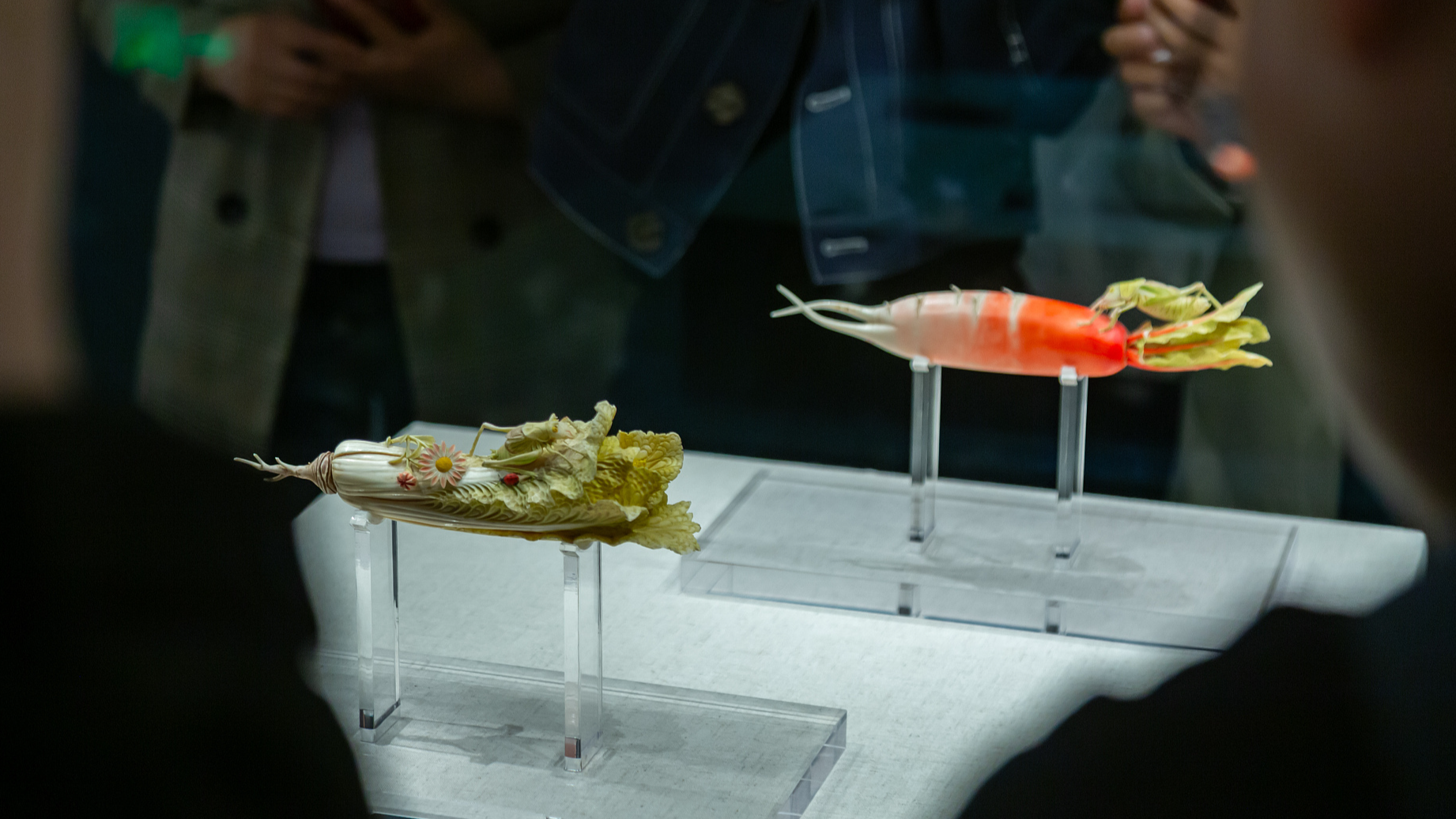 A photo taken on May 5, 2024 shows people appreciating ivory radish and cabbage on display at Henan Museum in Zhengzhou, Henan Province, China. /CFP