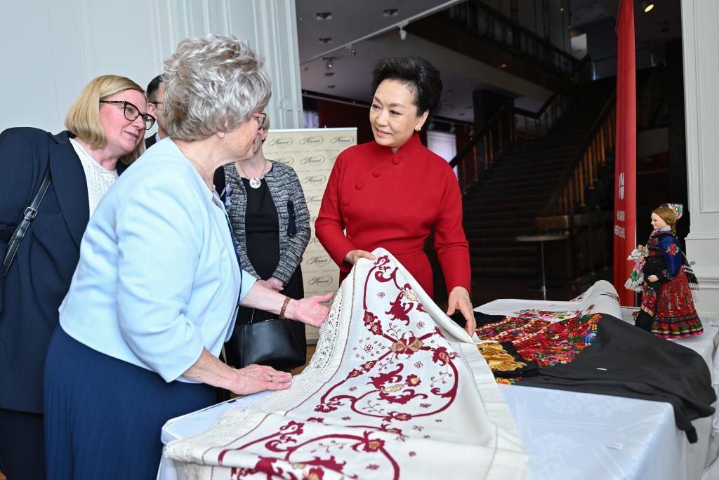 A photo taken on May 9, 2024 shows Peng Liyuan, wife of Chinese President Xi Jinping, and Zsuzsanna Nagy, wife of Hungarian President Tamas Sulyok, appreciate the exhibition of Hungarian traditional embroidery craftsmanship in Budapest, Hungary. /Xinhua