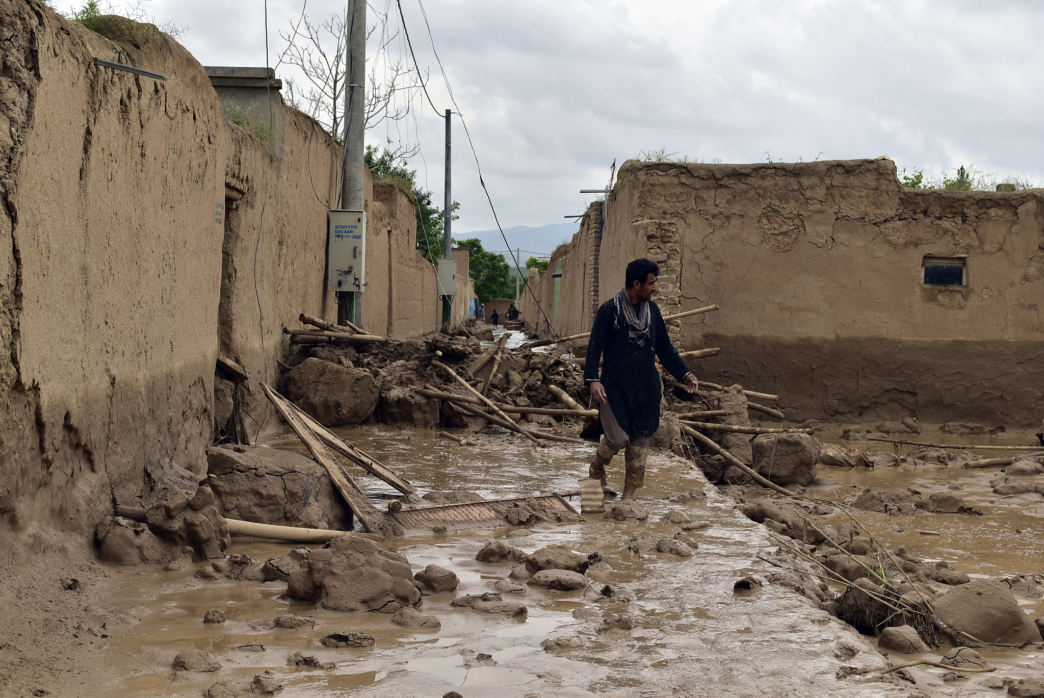 An Afghan man walks near his damaged home after heavy flooding in Baghlan province in northern Afghanistan, May 11, 2024. /CFP