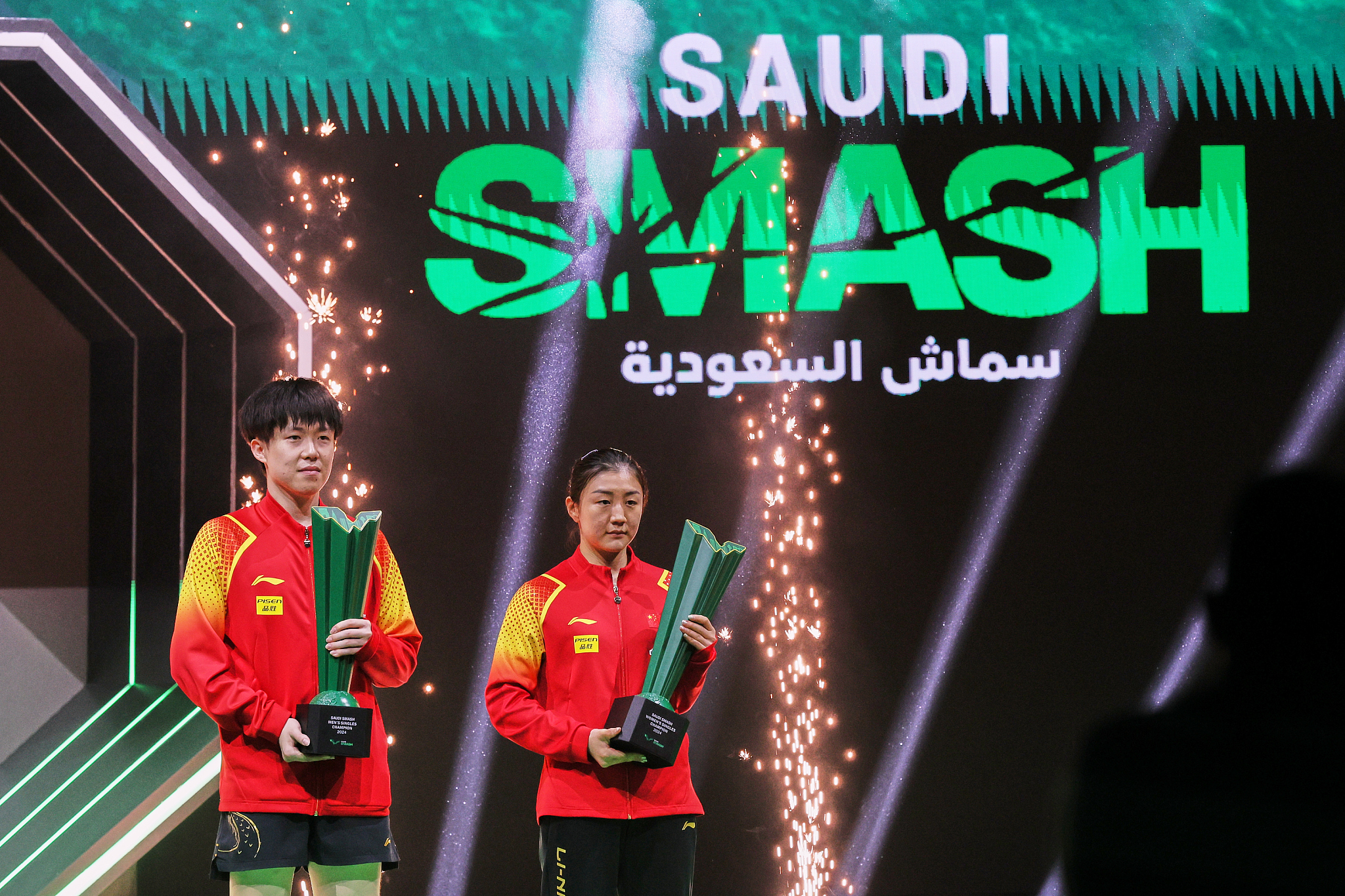 Wang Chuqin (L) and Chen Meng celebrate winning the men's and women's singles titles, respectively, at the 2024 WTT Saudi Smash in Jeddah, Saudi Arabia, May 11, 2024. /CFP