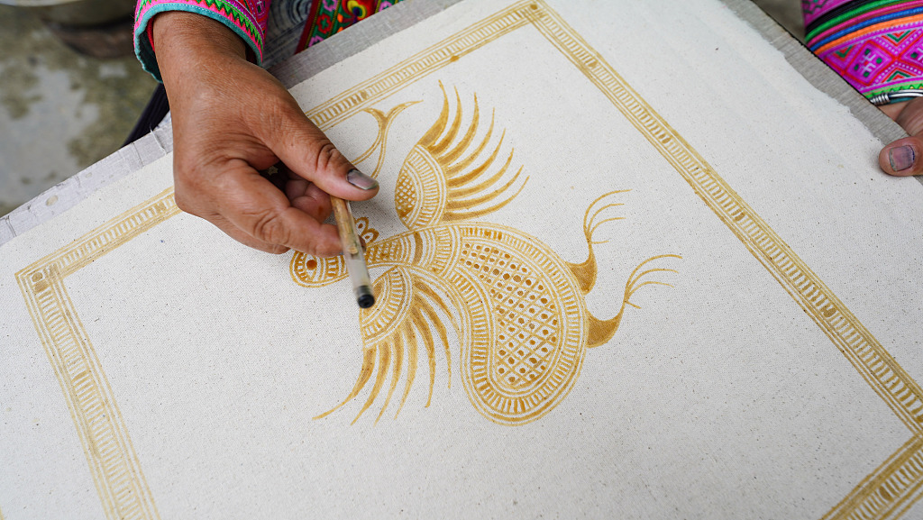 A woman of the Miao ethnic group is busy working on Miao batik products to meet market demand in Rongjiang County, Guizhou Province, April 24, 2024. /CFP