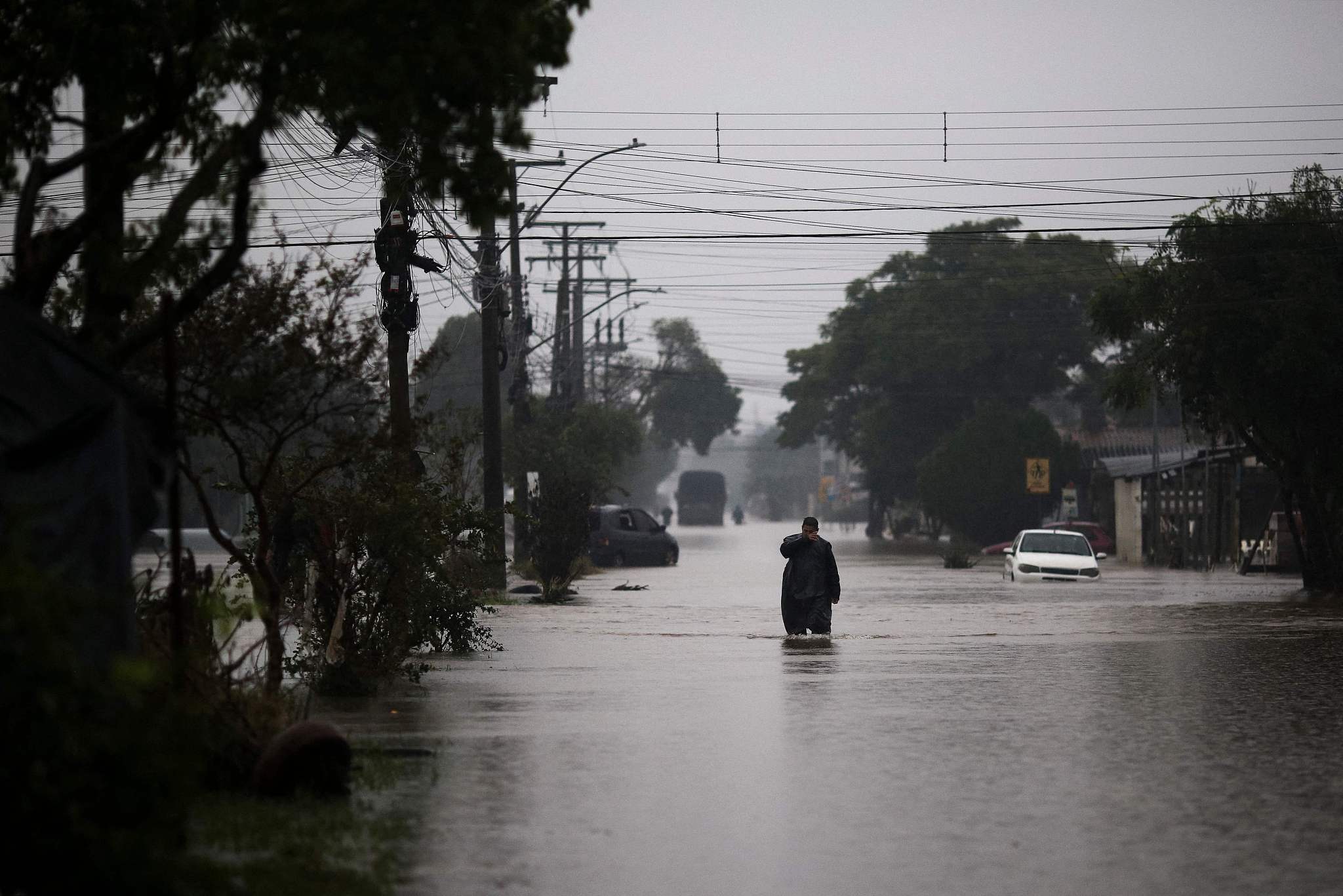 A man walks in a flooded street in Eldorado do Sul, Rio Grande do Sul state, Brazil, May 12, 2024. /CFP