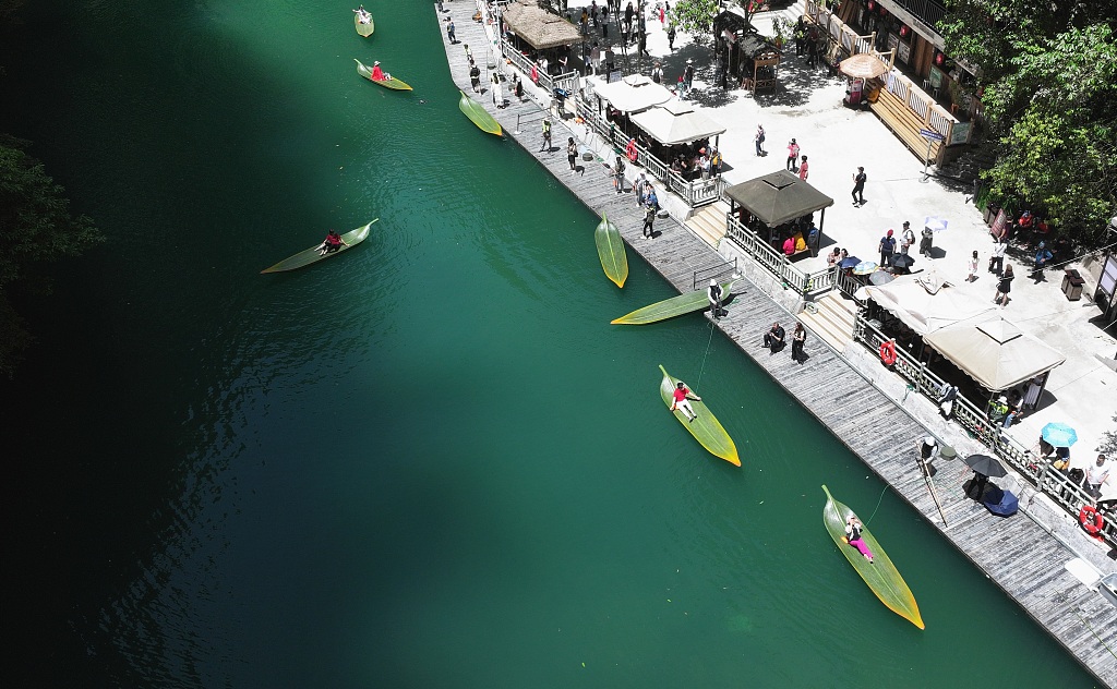 An aerial photo shows leaf-shaped boats floating on the clear waters of Pingshan Canyon in Enshi, Hubei Province on May 13, 2024. /CFP