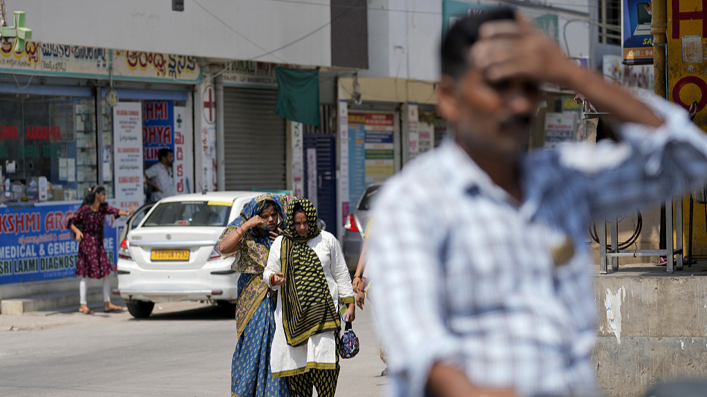 Women use scarves to shield themselves from the sun on a hot day in Hyderabad, India, May 2, 2024. /CFP