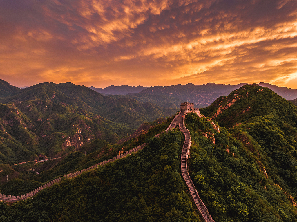 Rolling clouds are lit by evening light in the sky above the Juyong Pass at the Great Wall in Changping District, Beijing, May 14, 2024. /CFP