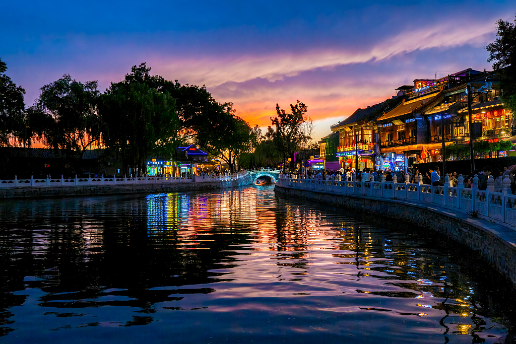 The lights of shops and restaurants twinkle as dusk sets in at the Shichahai scenic area in Beijing, May 14, 2024. /CFP