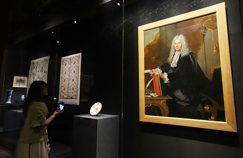 People visit the joint exhibition showcasing exchanges between China and France in the 17th and 18th centuries, in Beijing, May 14, 2024. /CFP