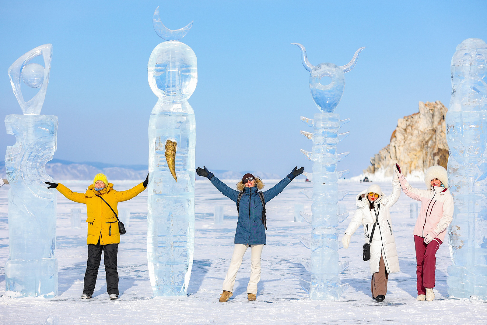 Visitors pose for photos with ice sculptures during the Olkhon Ice Fest on the shores of Lake Baikal's Olkhon Island in Russia on February 17, 2024. /CFP