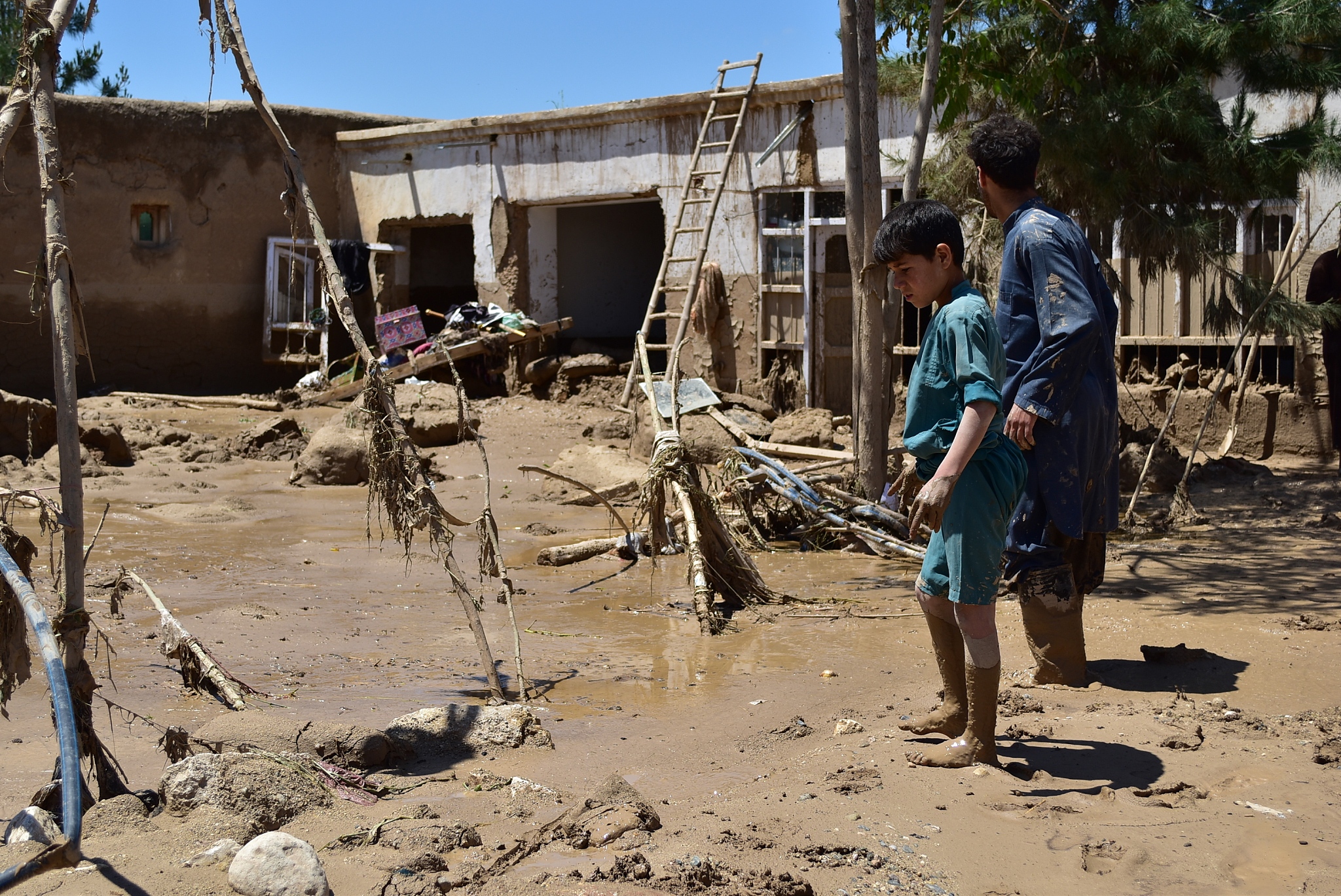 People look at destroyed houses after torrential rain and devastating floods in Baghlan province of Afghanistan, May 12, 2024. /CFP