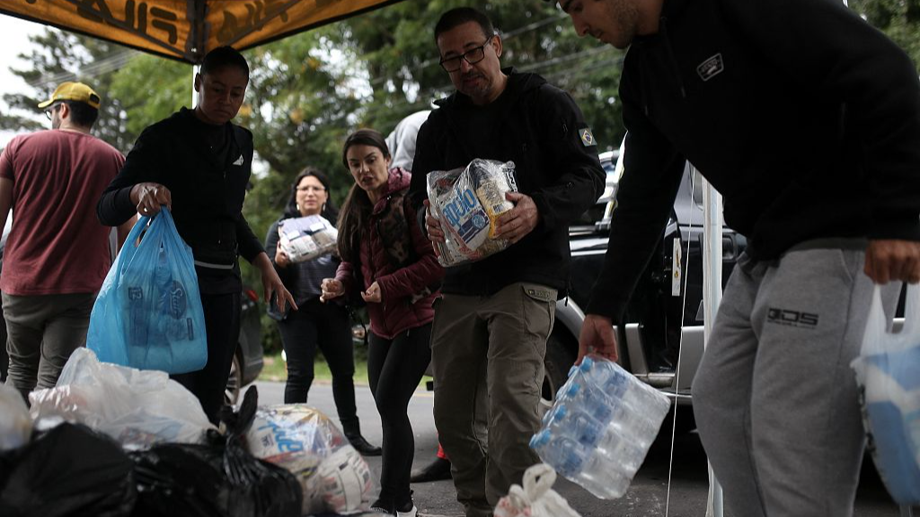 Volunteers organize donations to be taken to Guaiba for flood victims in Porto Alegre, Rio Grande do Sul state, Brazil, on May 13, 2024. /CFP