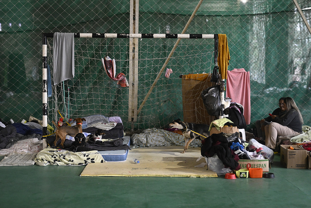 Residents rest in a gymnasium converted into a makeshift shelter for people whose homes were flooded by heavy rains in Canoas, metropolitan region of Porto Alegre, Brazil, May 10, 2024. /CFP