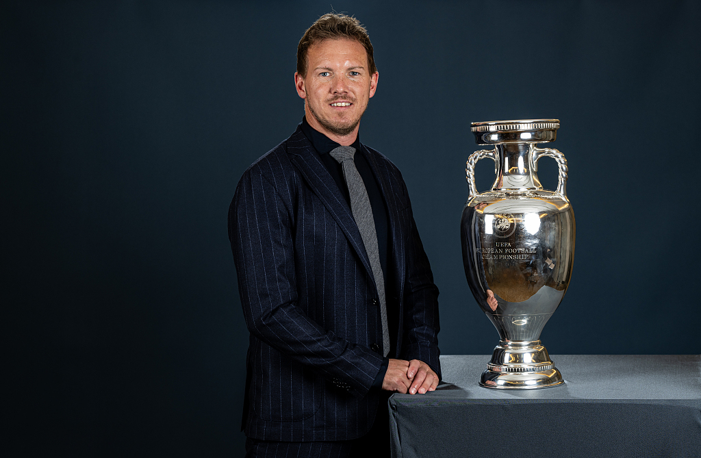 Julian Nagelsmann, manager of Germany, poses with the Henri Delaunay Trophy for the UEFA European Championship in Dusseldorf, Germany, April 8, 2024. /CFP
