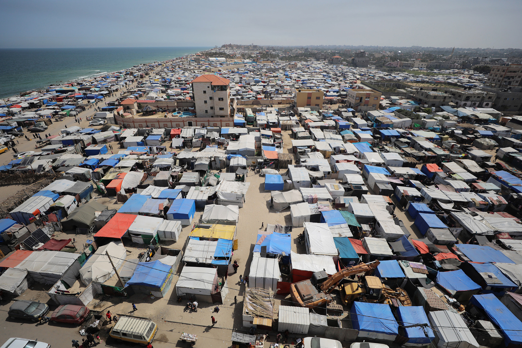 An aerial view of the makeshift tents set up in the coastal area as Palestinians, who left their homes due to Israeli attacks, try to survive under difficult conditions in Deir al-Balah, Gaza on May 16, 2024. /CFP