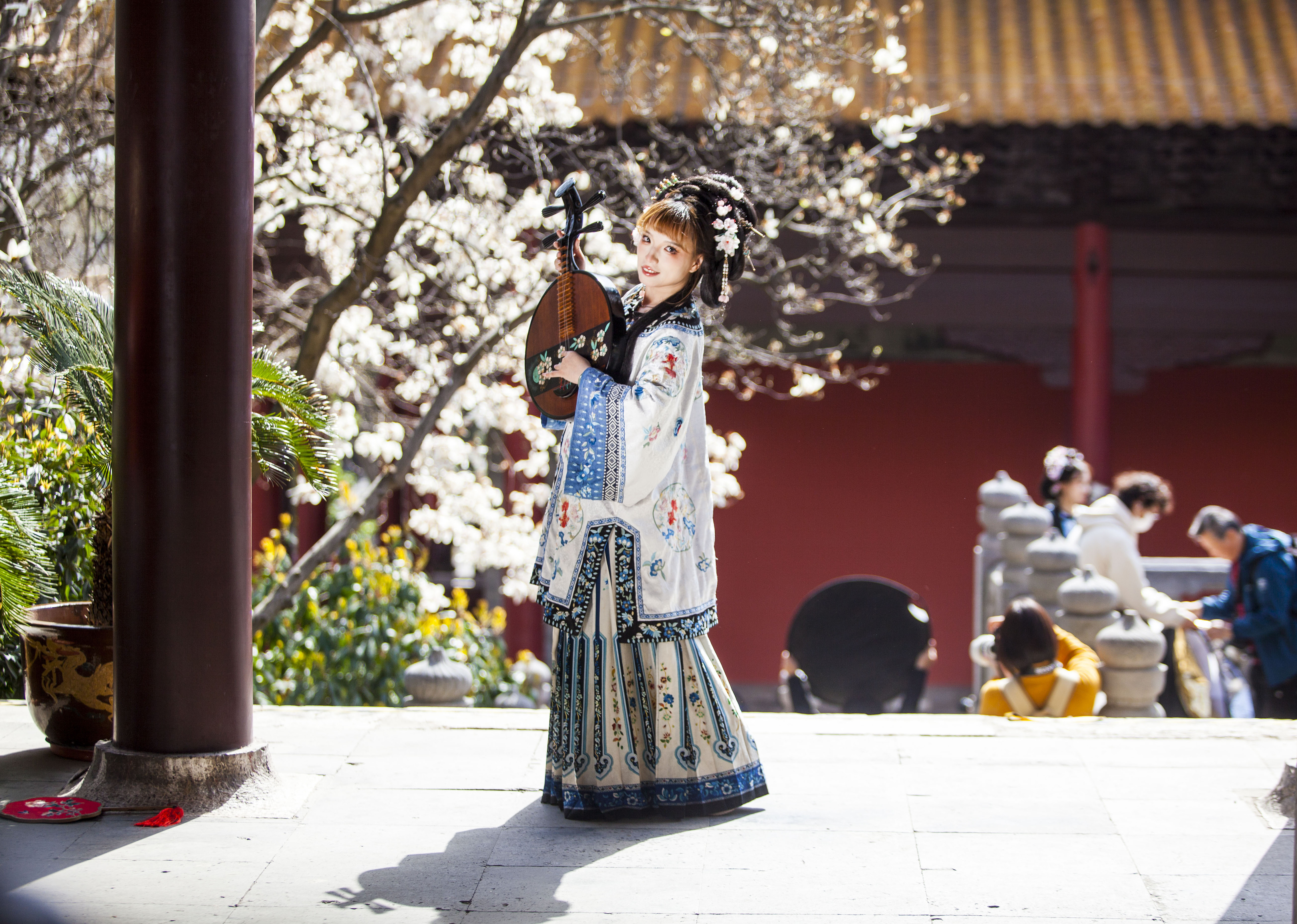 A visitor dressed in traditional Chinese clothing poses for a photo at the Chaotian Palace, also Nanjing Municipal Museum, Nanjing, east China's Jiangsu Province, March 19, 2024. /CFP