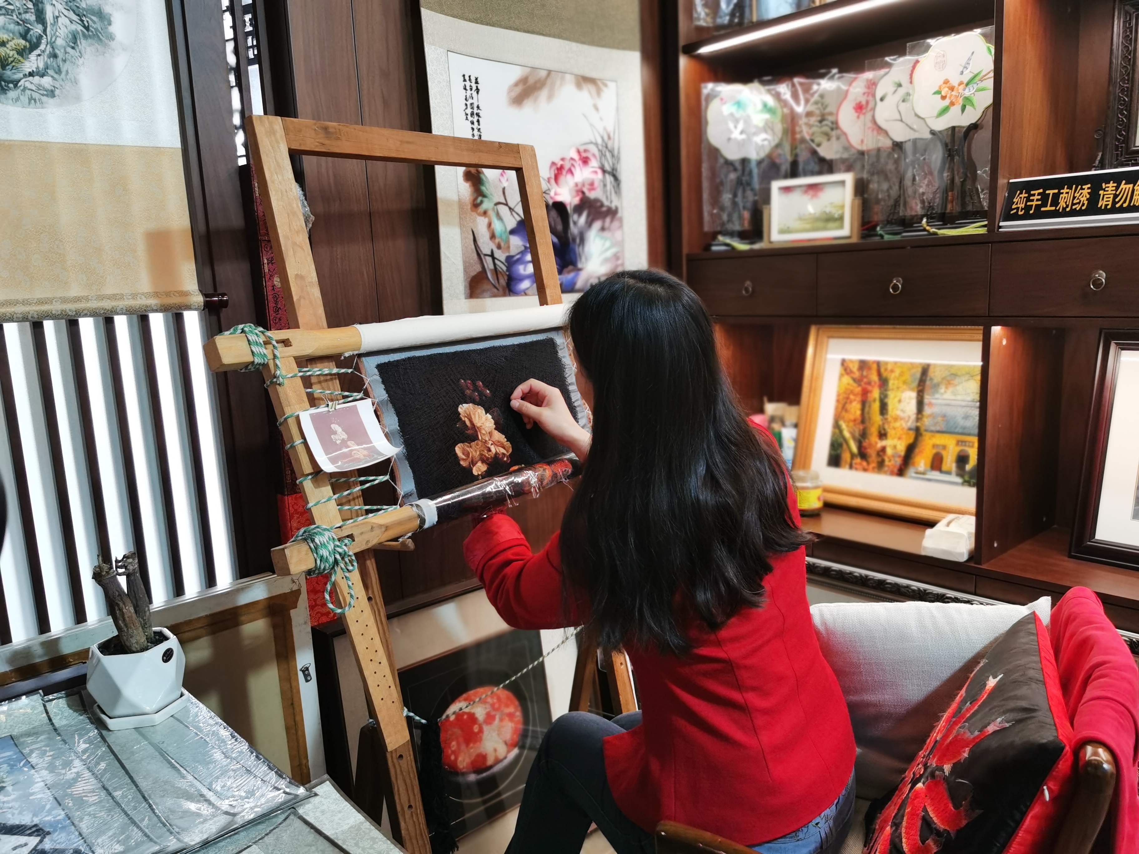 A woman works on an embroidery piece in her studio at Nanjing Folk Museum, Nanjing, east China's Jiangsu Province, April 23, 2024. /CGTN