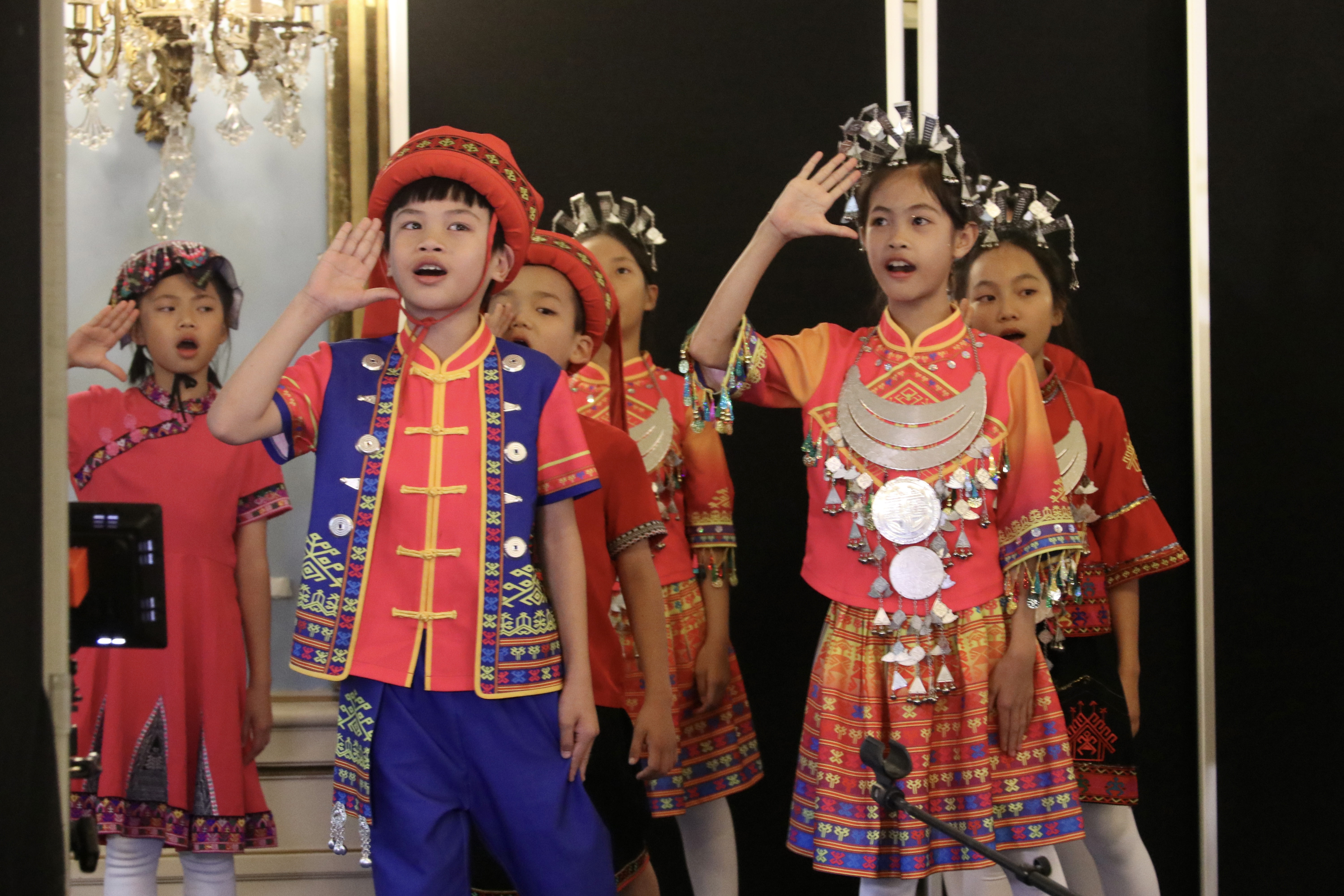 Members of the Wuzhishan Li and Miao Children's Choir from Wuzhishan, Hainan Province perform during a concert in Paris, France. /Photo provided to CGTN