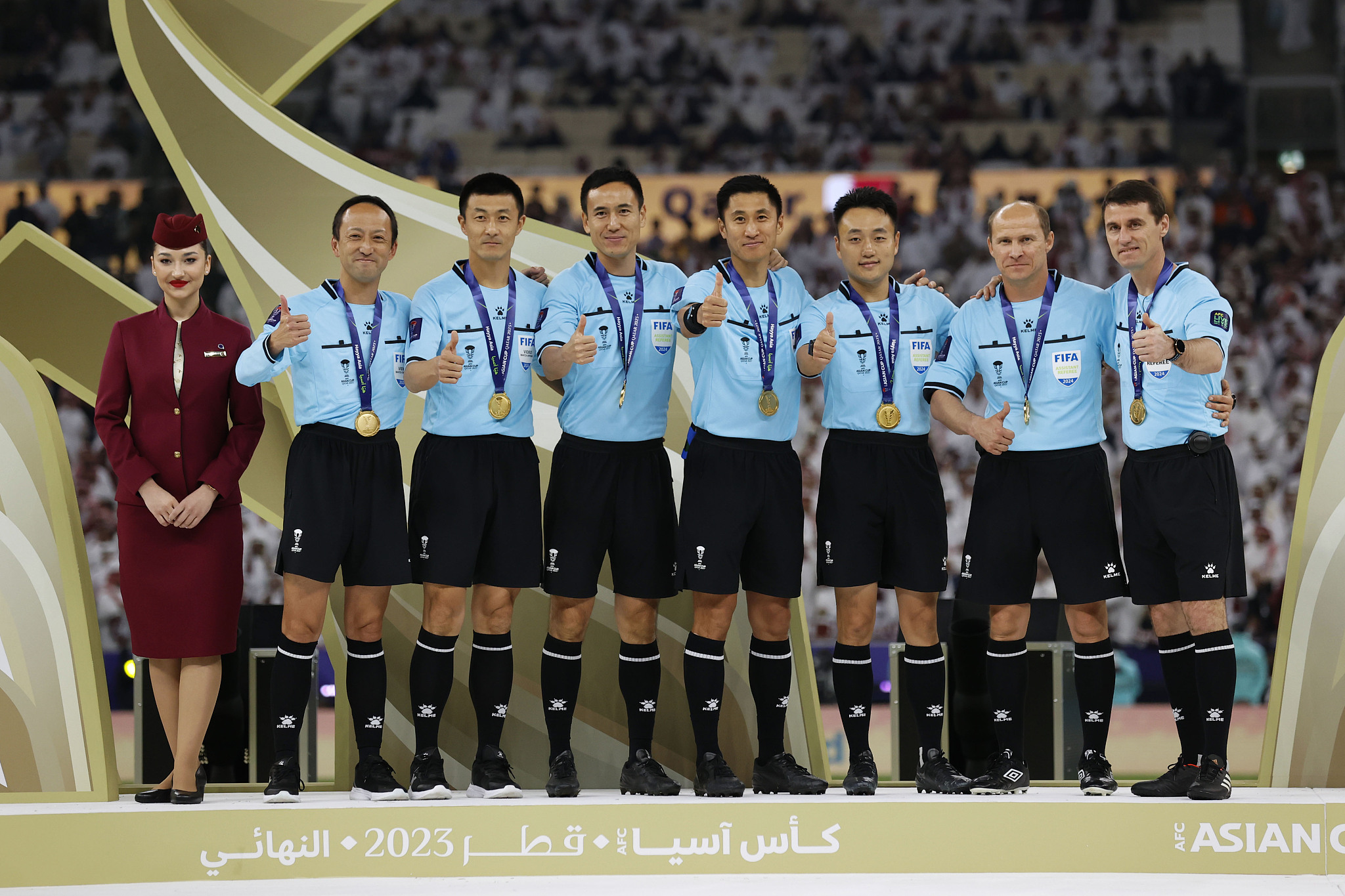 Fu Ming (L2) during the awarding ceremony after the Asian Cup final between Jordan and Qatar at the Lusail Stadium in Doha, Qatar, February 10, 2024. /CFP