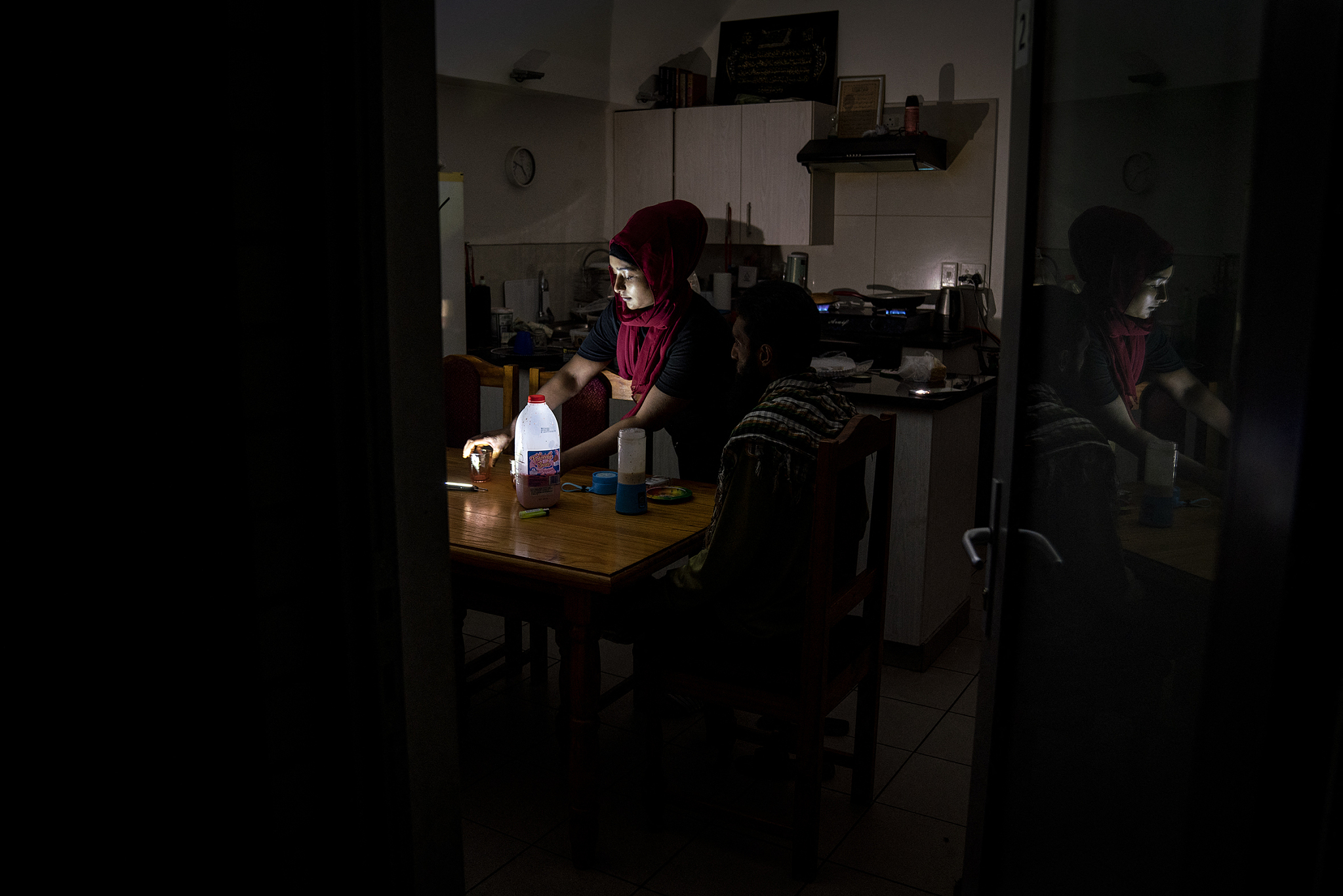 Residents use portable lamps to brighten their kitchen during rolling blackouts, Johannesburg, South Africa, April 12, 2023. /CFP