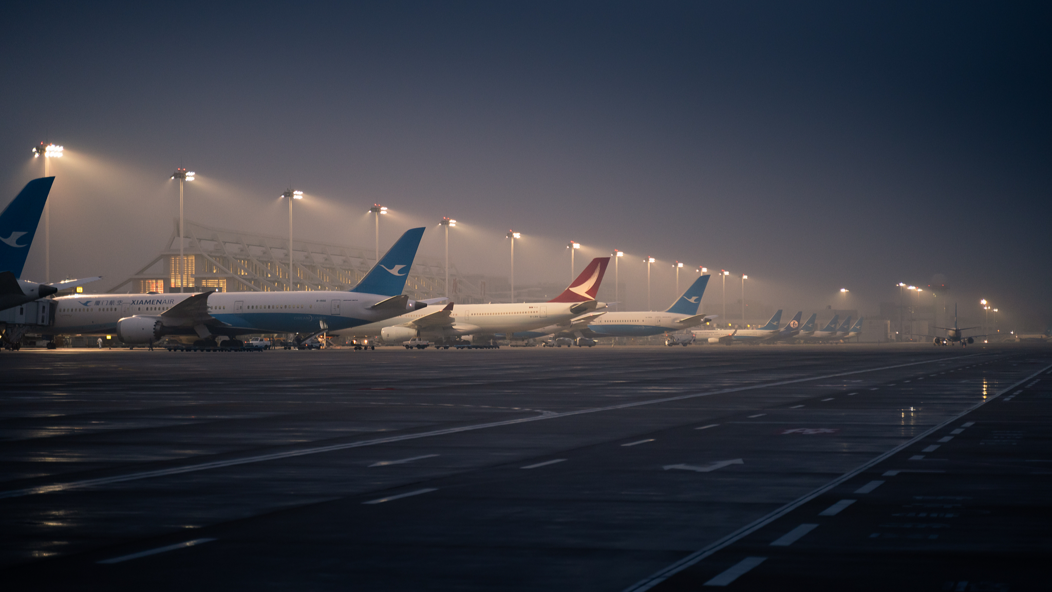 Planes are ready to take off at dawn at Xiamen Gaoqi International Airport, December 25, 2019. /CFP