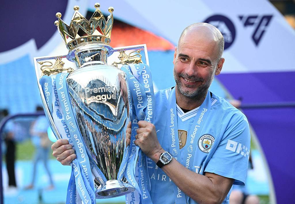 Pep Guardiola, manager of Manchester City, celebrates with the Premier League championship trophy at the Etihad Stadium in Manchester, England, May 19, 2024. /CFP