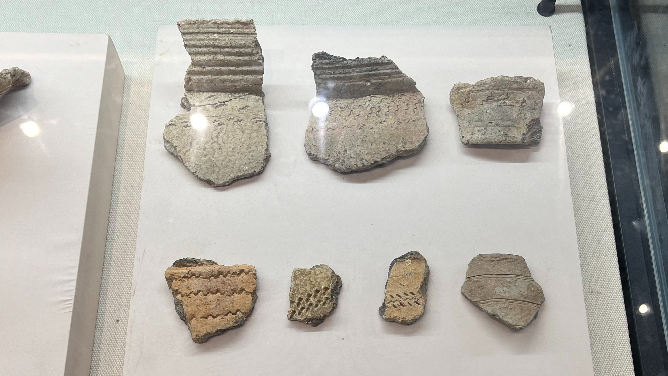 A photo taken on May 21, 2024 shows fragments of pottery featuring a variety of patterns unearthed at the Keqiutou site on display at a museum in Fuzhou, Fujian Province, China. /CGTN