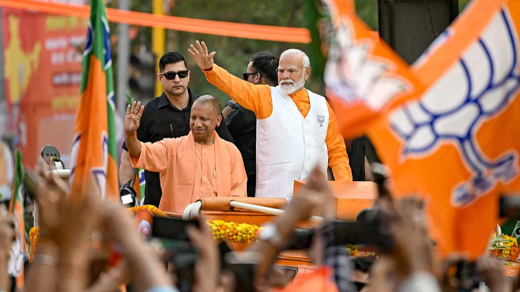 Narendra Modi (R), Indian prime minister and leader of the ruling Bharatiya Janata Party (BJP), waves to the crowd during his roadshow on the eve of filing of his election nomination papers, Varanasi, India, May 13, 2024. /CFP