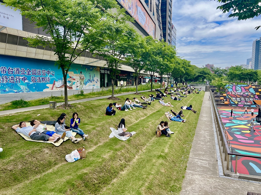 A photo taken on May 22, 2024 shows people relaxing on the tiered lawn in Shanghai, China. /CFP