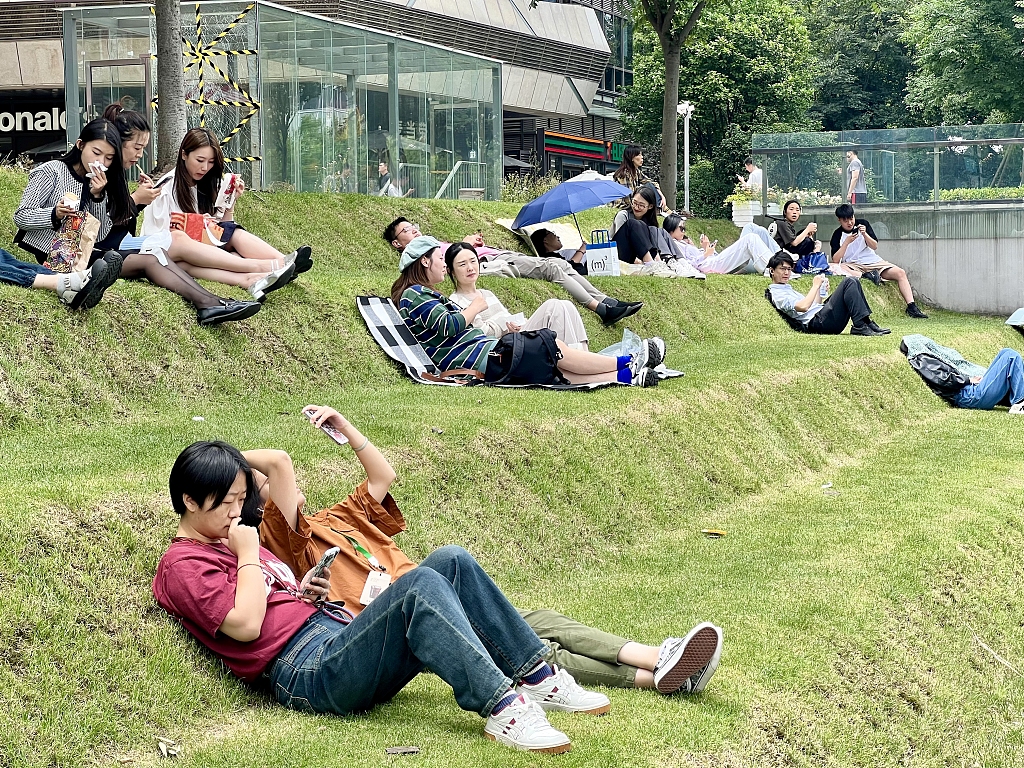 A photo taken on May 22, 2024 shows people relaxing on the tiered lawn in Shanghai, China. /CFP