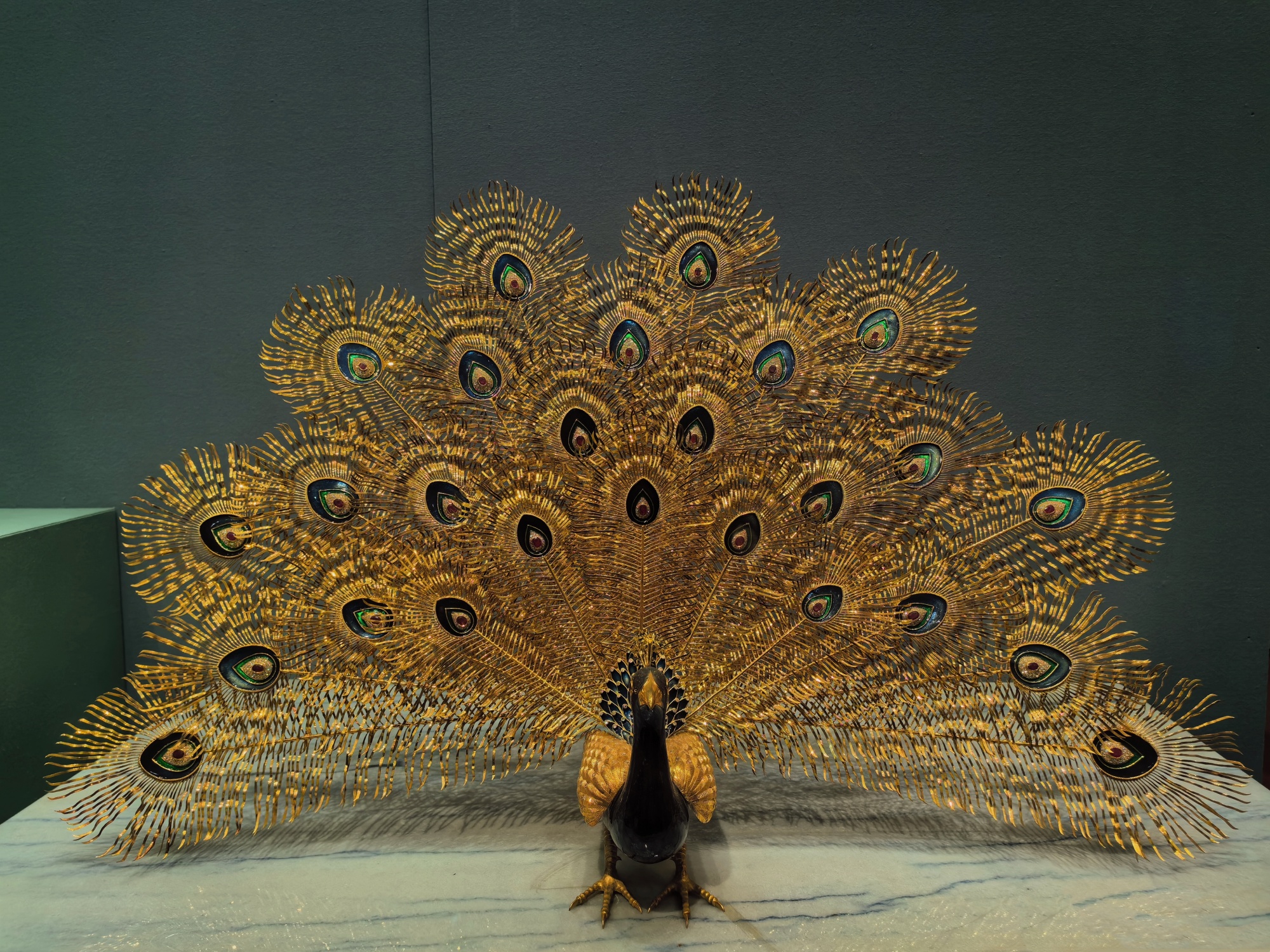 A golden peacock given by former President Zayed bin Sultan of the United Arab Emirates in 1990 is on display at the Central Gifts and Cultural Relics Management Center in Beijing, on May 23, 2024. /CGTN
