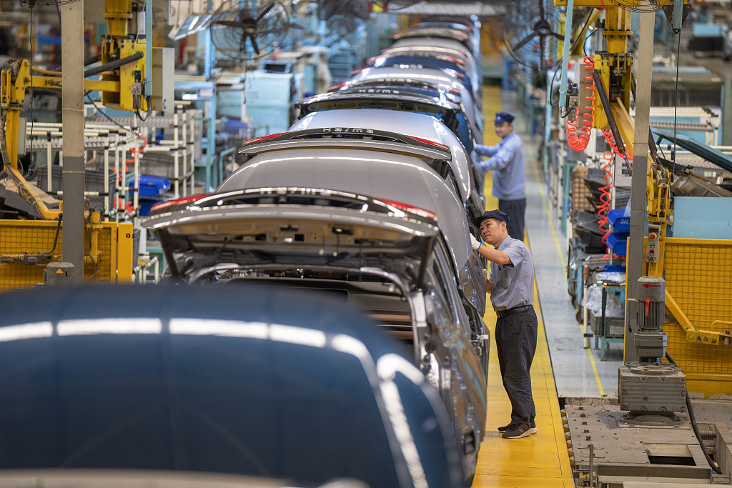 Staff work on the production line of new energy vehicles at a workshop of Haima Motor in Haikou, China, October 11, 2022./CFP