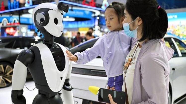 A girl interacts with an AI robot at the fourth China International Consumer Products Expo in Haikou City, capital city of south China's Hainan Province, April 15, 2024. /Xinhua
