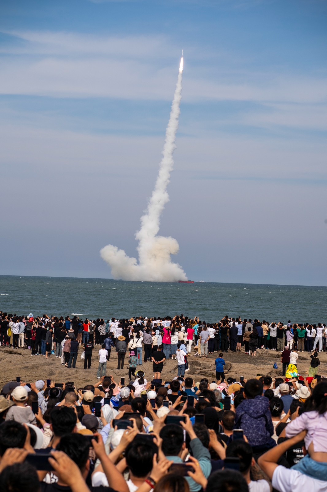 People watch the launch of the CERES-1S Y2 carrier rocket off the coast of east China's Shandong Province, May 29, 2024. /Courtesy of Galactic Energy