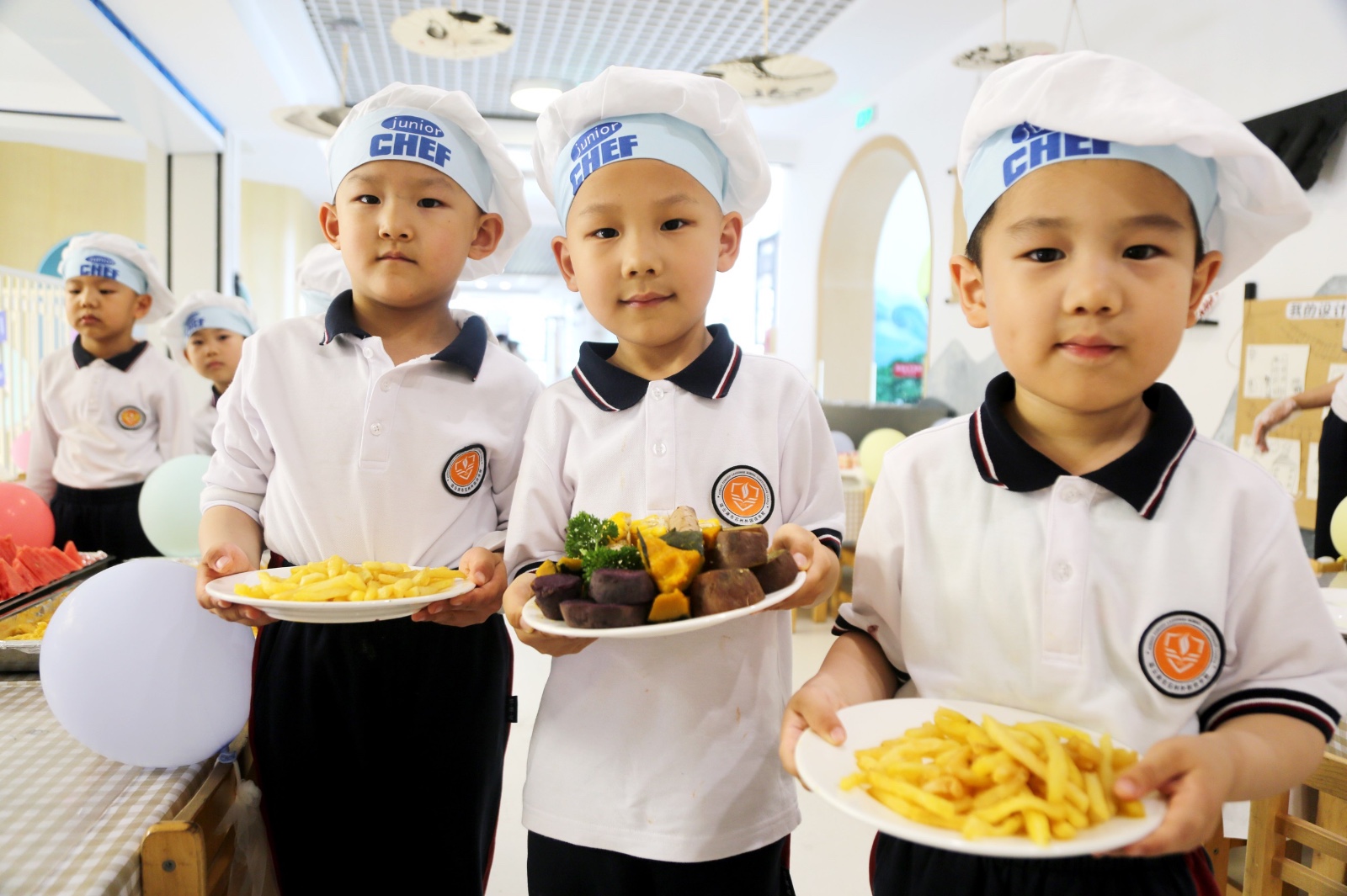 Boys pose with dishes they made during a food festival held at the affiliated kindergarten of Suzhou Foreign Language School in Lianyungang, Jiangsu Province on May 28, 2024. /IC