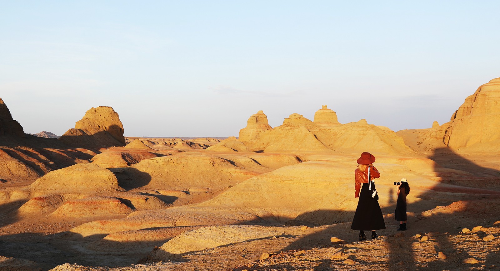 Visitors take photos of the wind-eroded landscape of the 