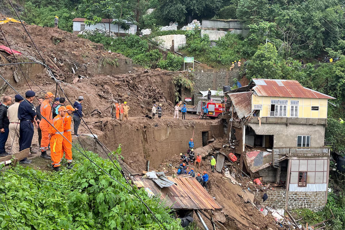 Rescue teams look for survivors amidst the debris next to a stone quarry that collapsed following torrential rains brought by Cyclone Remal on the outskirts of Aizawl, Mizoram, India, May 28, 2024. /Reuters