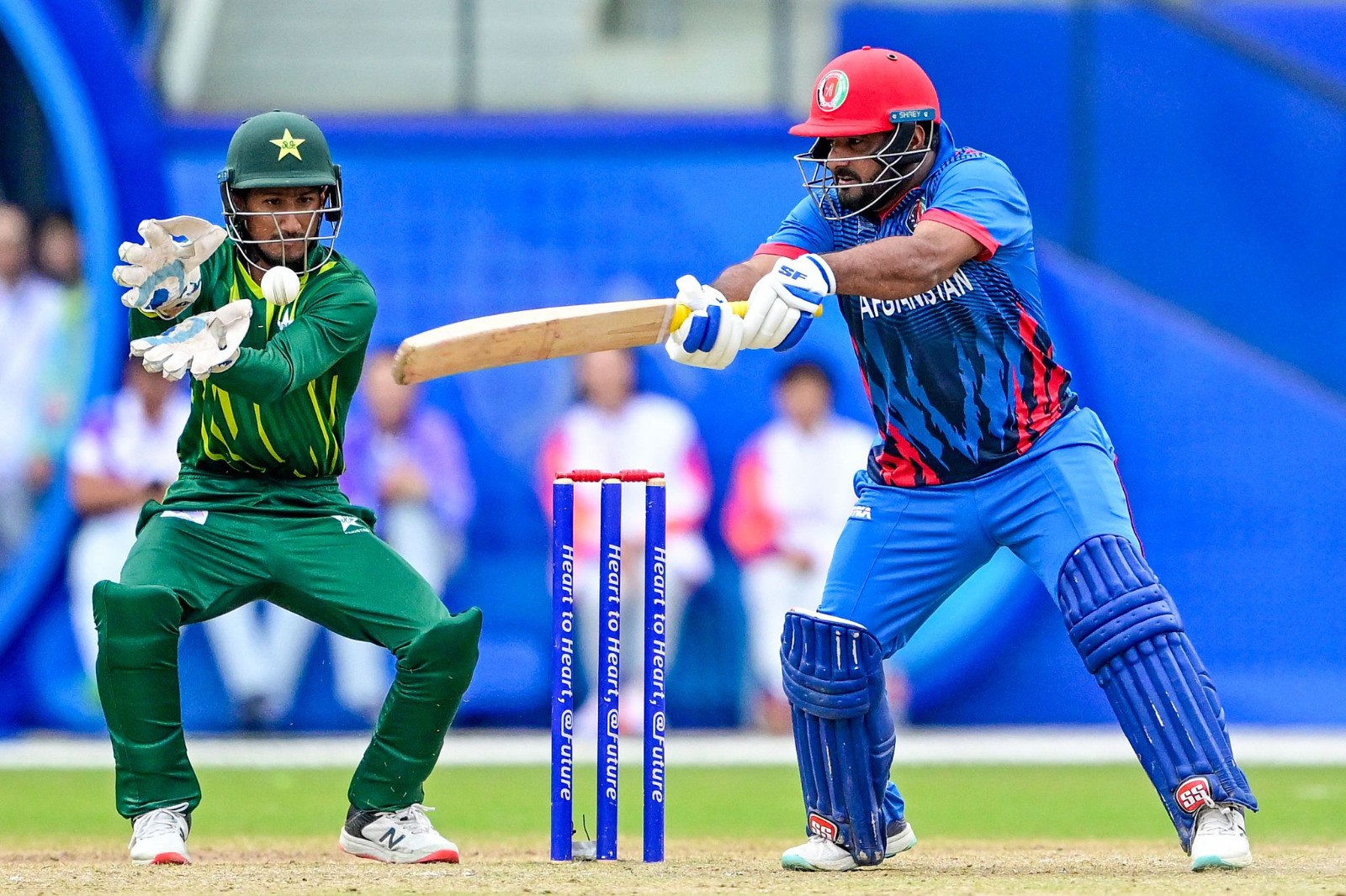 Afghanistan''s Mohammad Shahzad (R) plays a shot during the 2022 Asian Games men's second semifinal cricket match against Pakistan in Hangzhou in China's eastern Zhejiang Province on October 6, 2023. The Afghan national team is an emerging power in men's cricket. /CFP