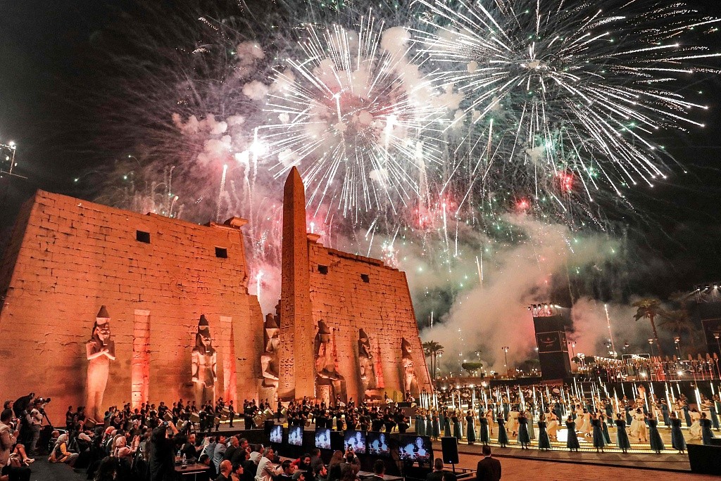 Fireworks light the sky during a ceremony outside the pylon and remaining obelisk at the entrance of the Temple of Luxor (built around 1400 BC) in Egypt's southern city of the same name on November 25, 2021. /CFP
