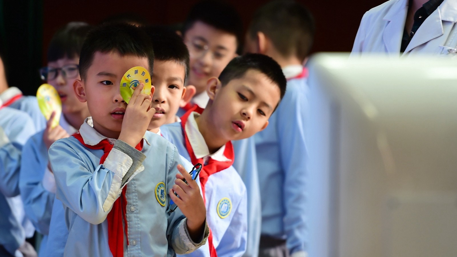 Students get vision checks at an elementary school in Cangzhou City, north China's Hebei Province, March 22, 2021. /CFP