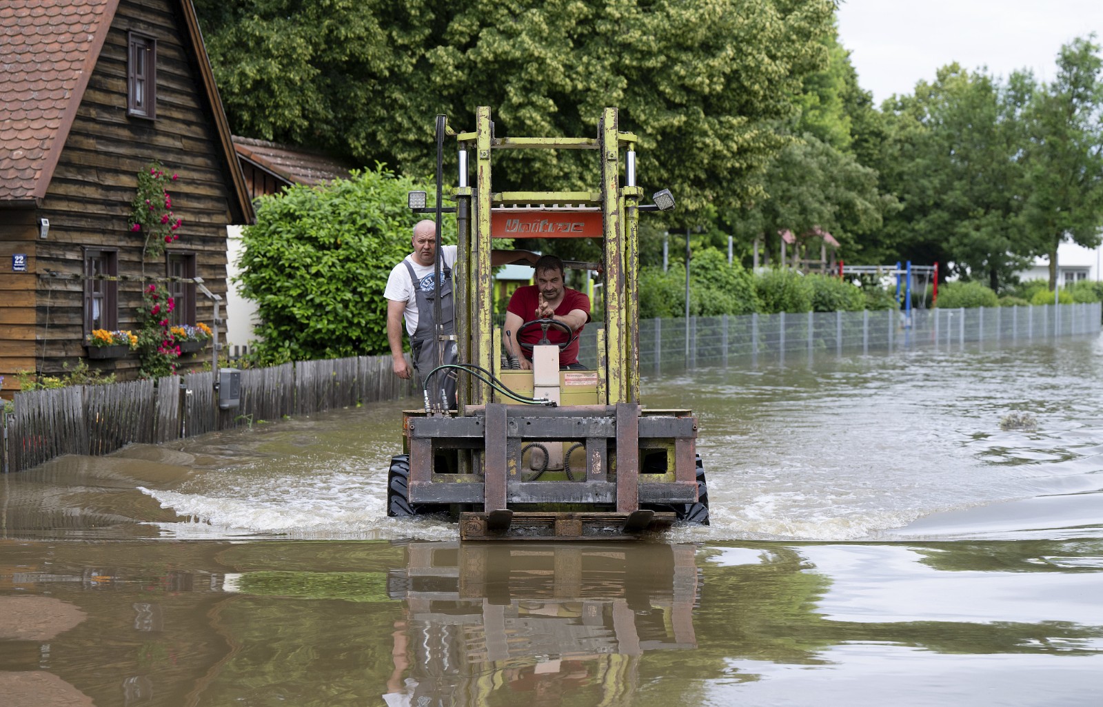 Helpers drive a forklift on a flooded street in the town center, Reichertshofen, Bavaria, southern Germany, June 2 2024. /AP