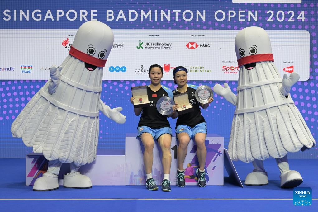 Jia Yifan (L) and Chen Qingchen of China celebrate after winning the women's doubles title at the Singapore Badminton Open in Singapore, June 2, 2024. /CMG