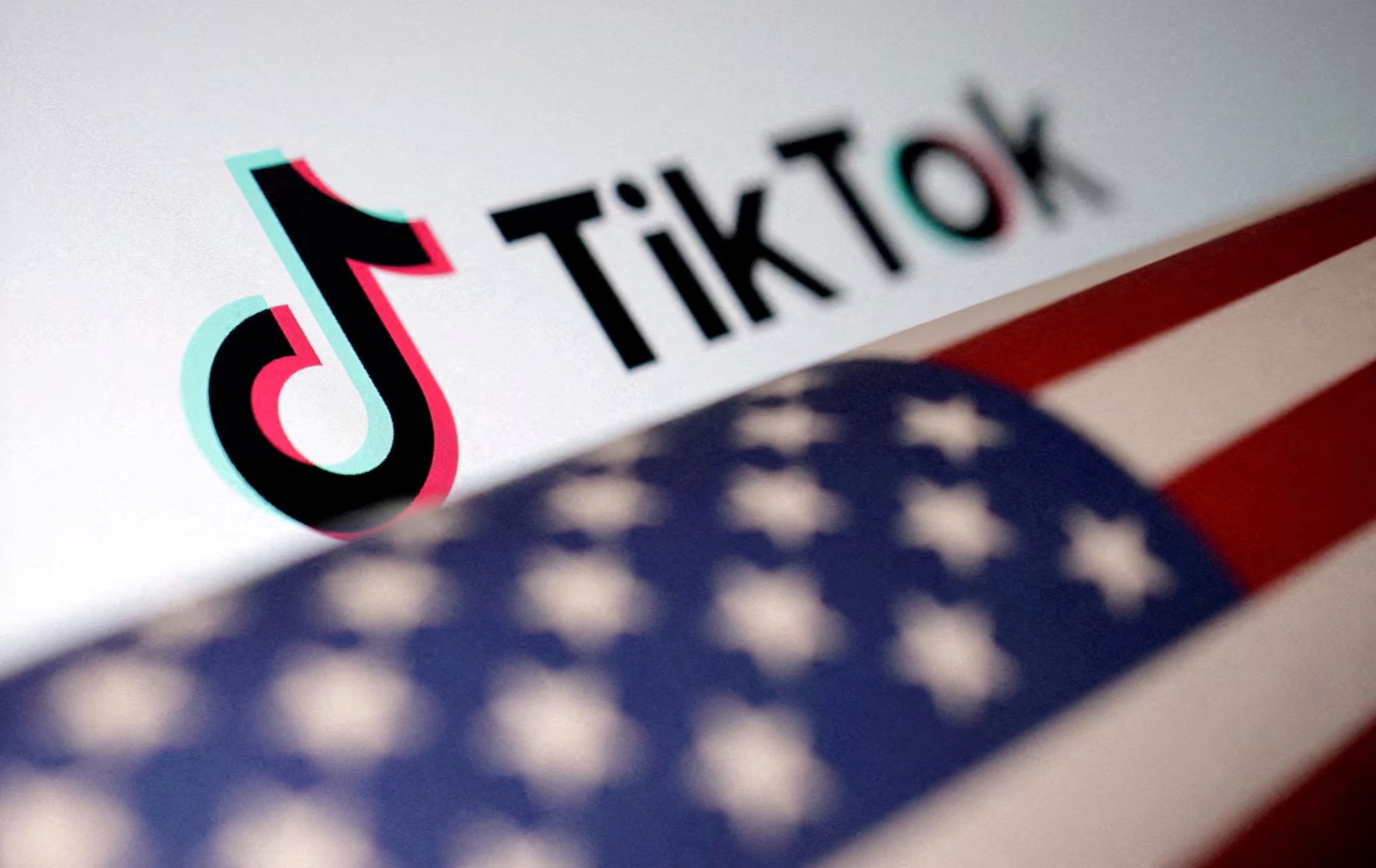 U.S. flag is placed on a TikTok logo in this illustration taken March 20, 2024. /Reuters