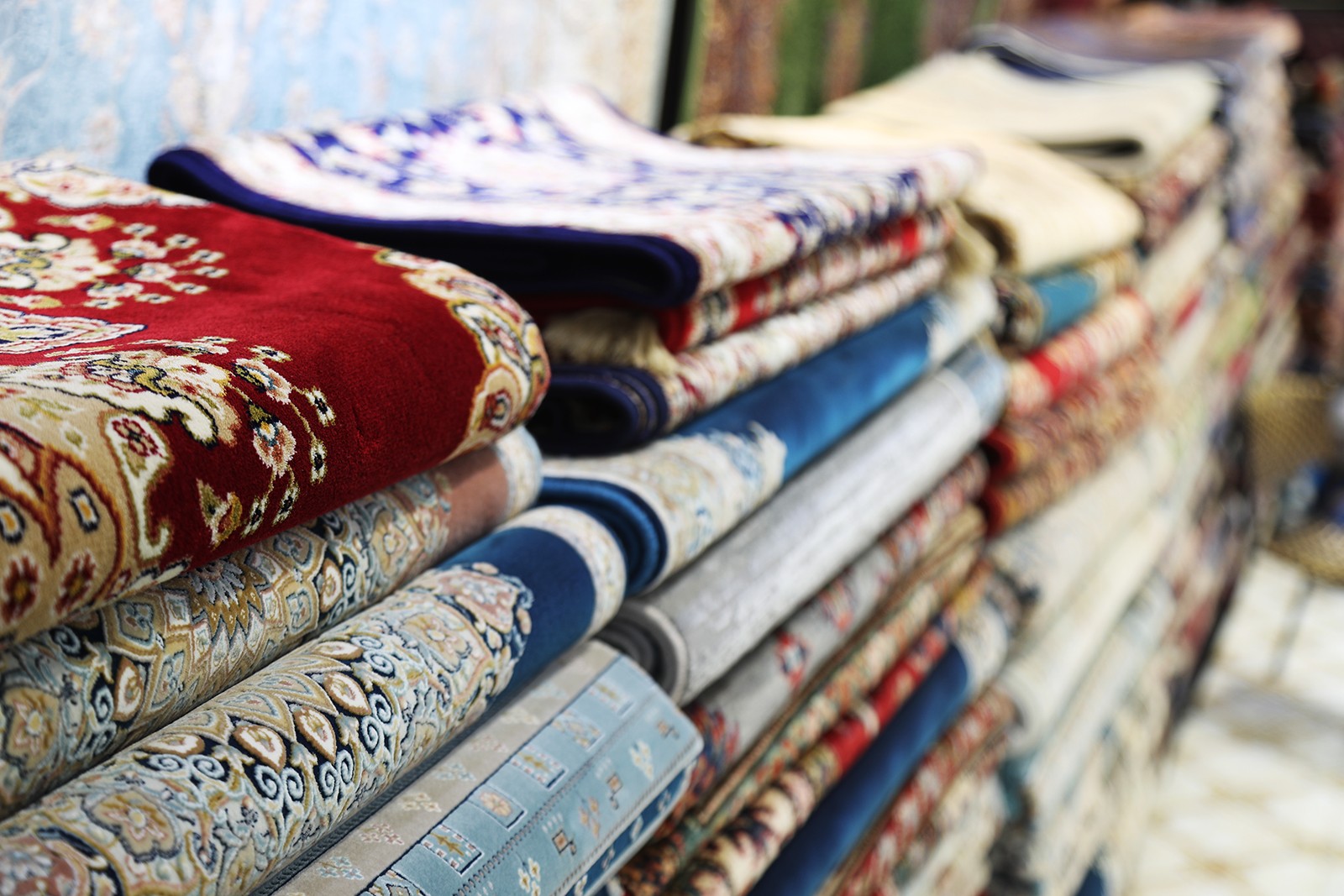 Stacks of carpets are displayed for sale at the Xinjiang International Grand Bazaar in Urumqi. /CGTN