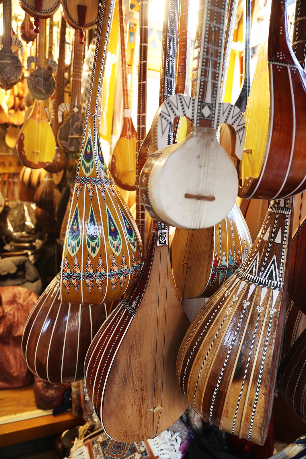 A diverse range of local musical instruments are displayed for sale at the Xinjiang International Grand Bazaar in Urumqi. /CGTN