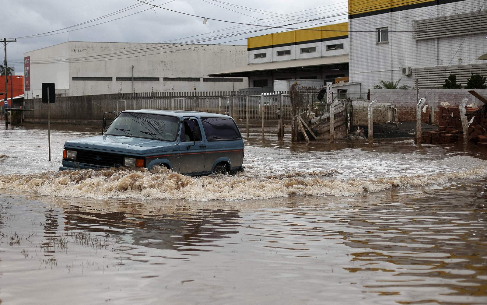 A car crosses a flooded street in Porto Alegre, Rio Grande do Sul, Brazil, May 26, 2024. /CFP