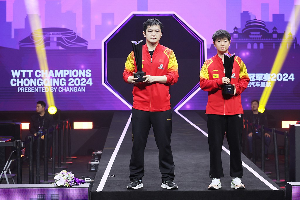 Fan Zhendong (L) and Sun Yingsha of China pose with their trophies after winning the men's and the women's singles finals at the World Table Tennis Chongqing Champions in southwest China's Chongqing Municipality, June 3, 2024. /CFP