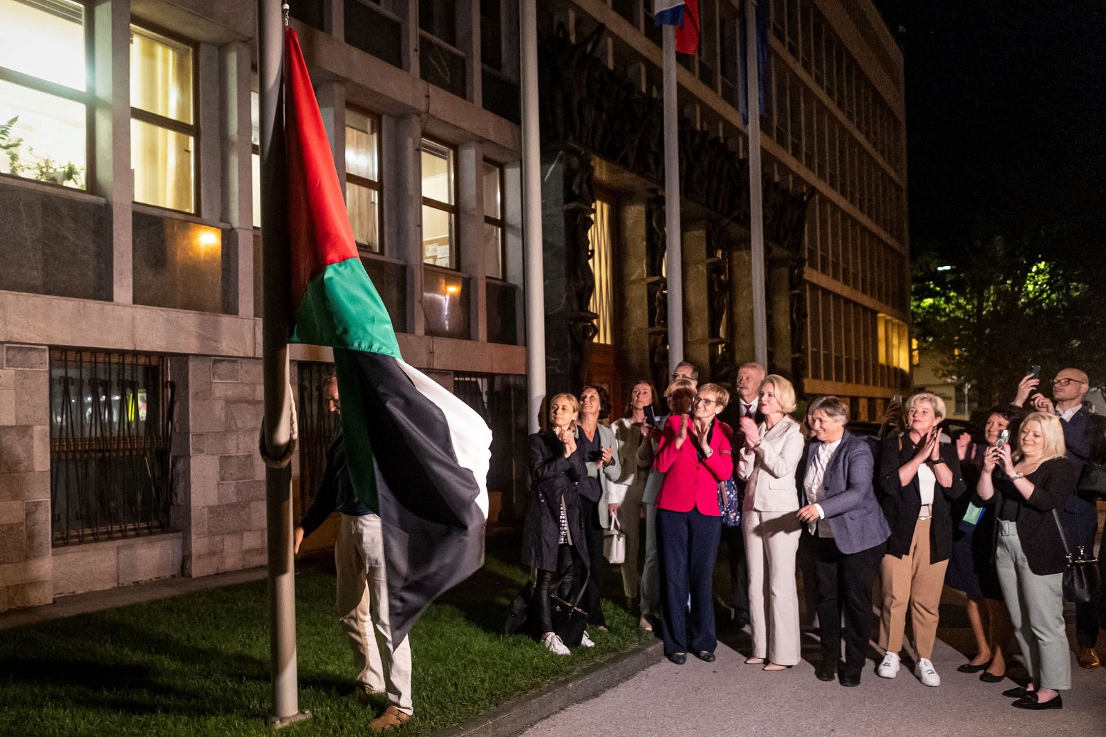 People hang a Palestinian flag in front of the parliament building after it recognized the Palestinian state following a parliamentary vote in Ljubljana, June 4, 2024. /CFP