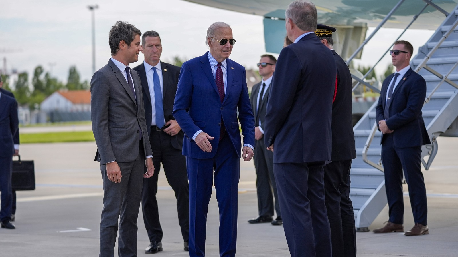 U.S. President Joe Biden is welcomed by France's Prime Minister Gabriel Attal, left,  upon his arrival at Orly airport, south of Paris, June 5, 2024. /CFP