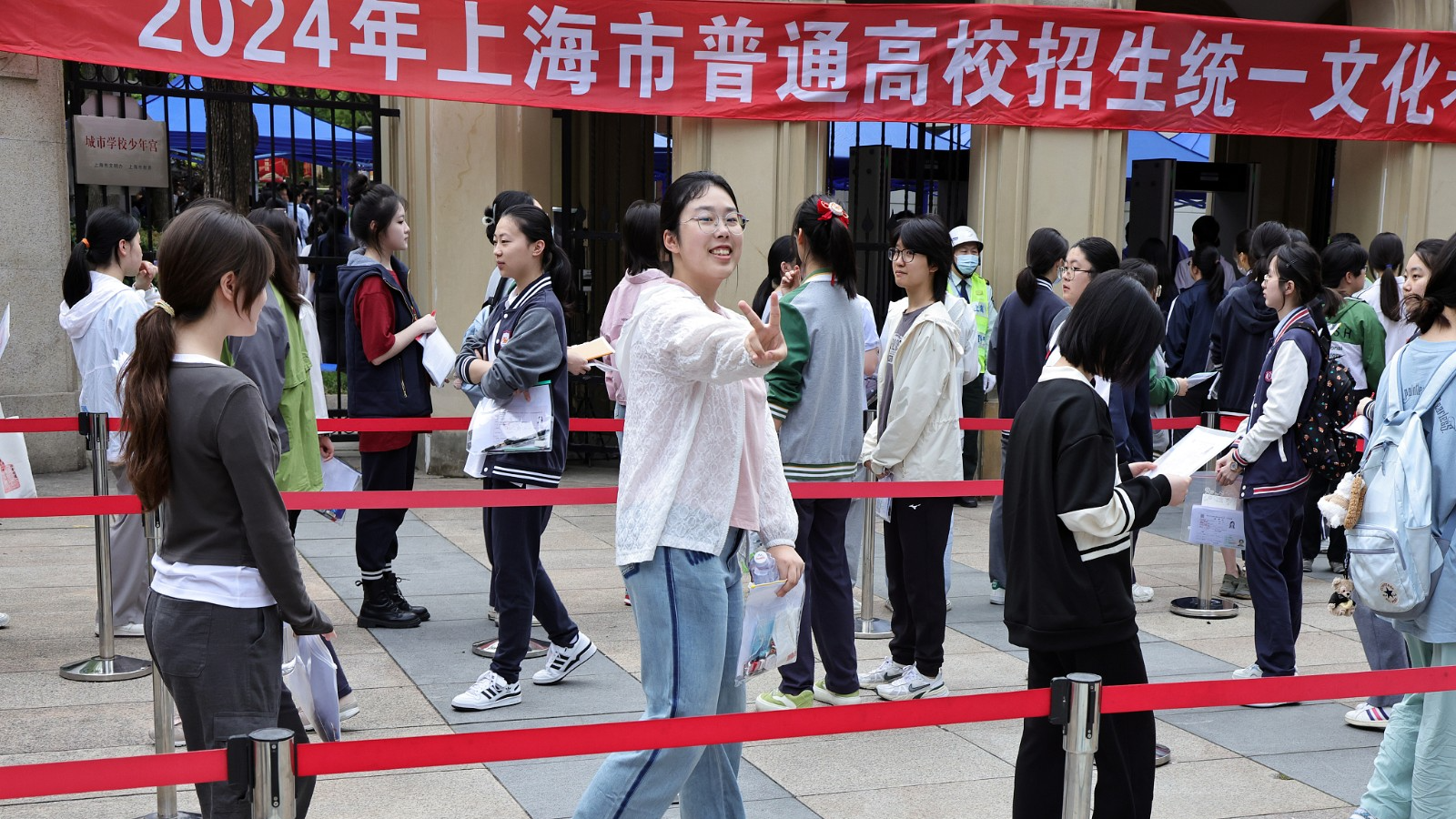 A student gestures while queuing to enter an examination site in Shanghai, China, June 7, 2024. /CFP