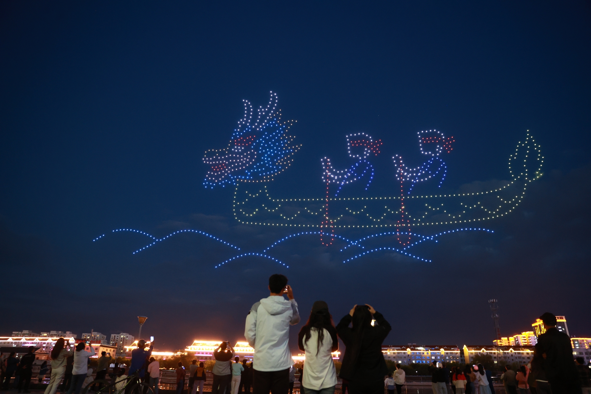 A dazzling drone display lights up the night sky over the Bu'erhatong River in Yanji, Yanbian Korean Autonomous Prefecture, northeast China's Jilin Province, on June 9, 2024. /CFP